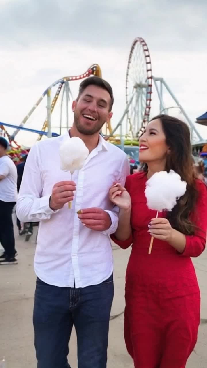 Dynamic couple intertwined in vibrant rollercoaster thrills Devouring fluffy cotton candy while joyfully walking Hand in hand amidst a kaleidoscope of color Excitement and laughter transform into passionate arguments Voices raised with tension palpable in air Defiant gazes as they storm away in opposite directions Seconds pass and serene moment unfolds on Ferris wheel Enveloped in soft twilight glowing hues Arms wrapped around each other offering solace High above the amusement park nostalgic vibes swirl beneath Retro rides and flickering lights mirror emotional rollercoaster of their love Story of passion and turmoil captured in enchanting visuals