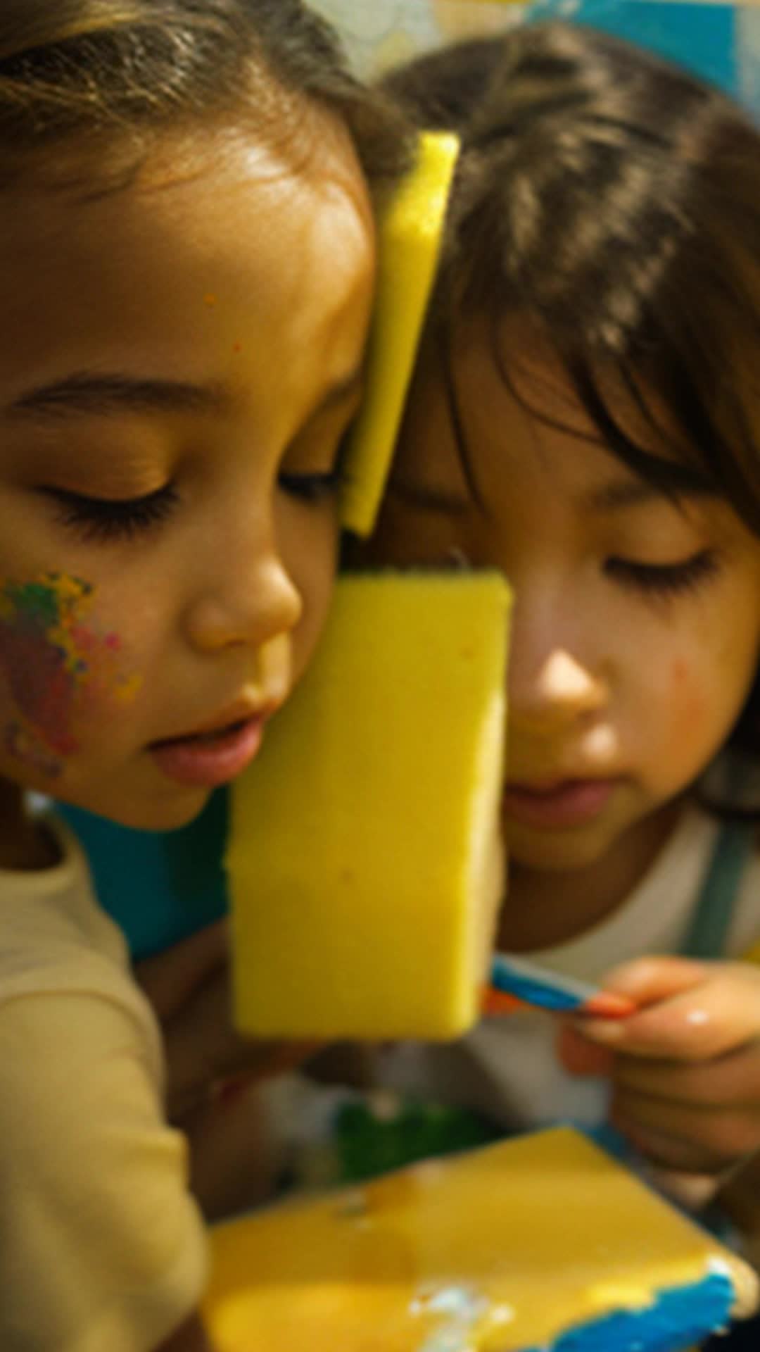 Eager children applying sponge-full of paints to mural, satisfying squish sounds, eager young artist's eyes watching, high detail capture, soft natural light, close-up