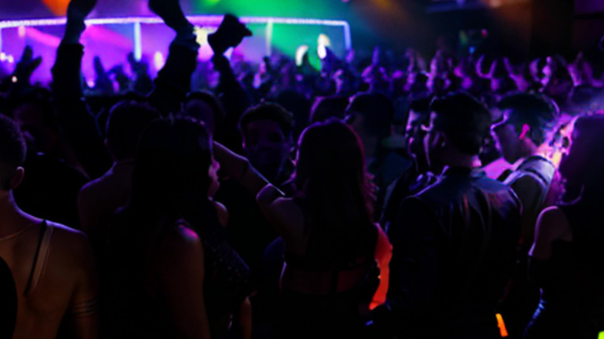 nightclub scene, lots of people dancing, bright neon lights