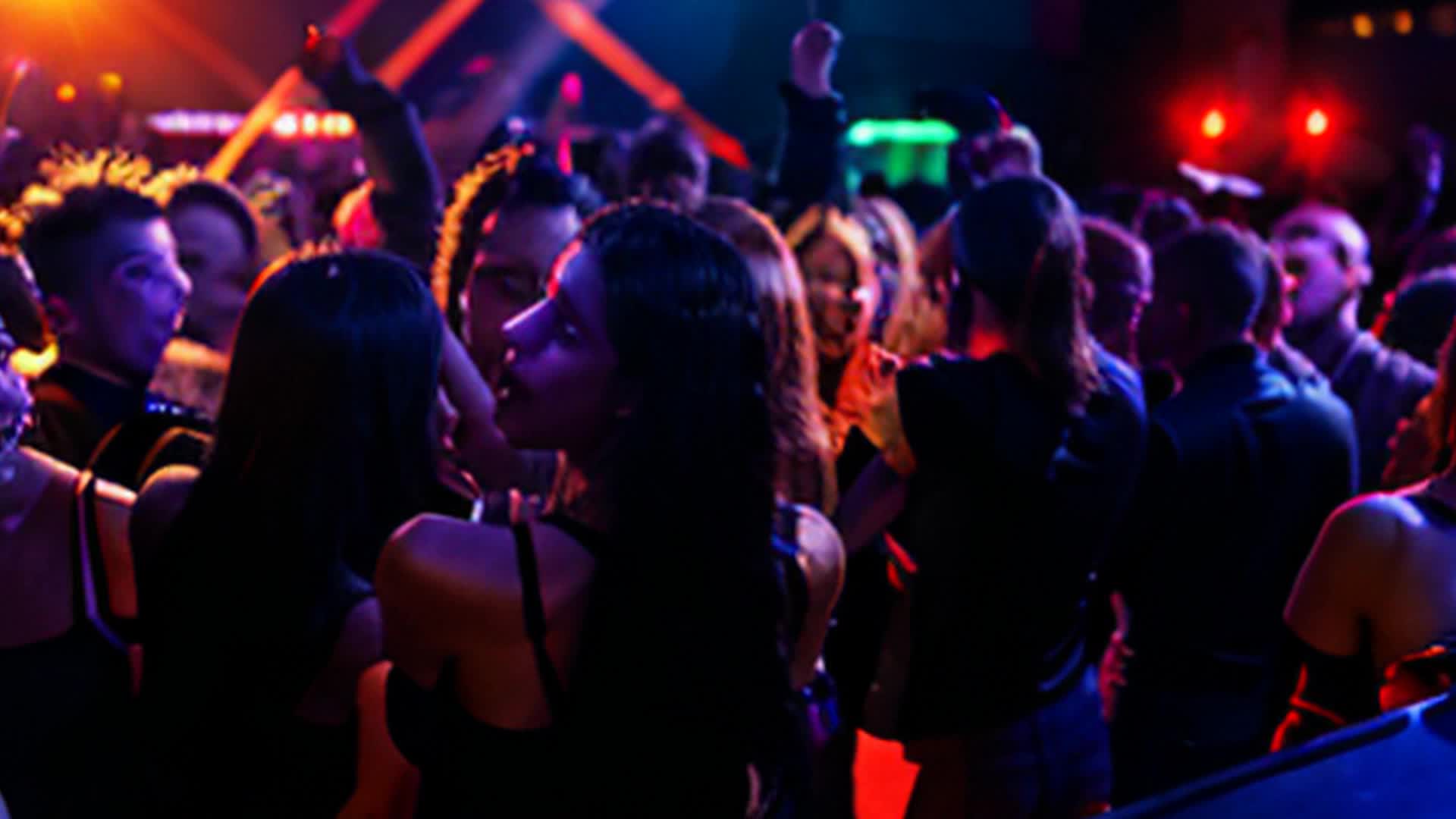 nightclub scene, lots of people dancing, bright neon lights