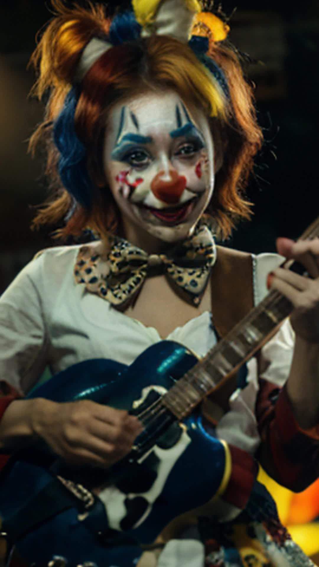 CLOWN GIRL WITH HER MIDDLE FINGER UP AND HOLDING A GUITAR 