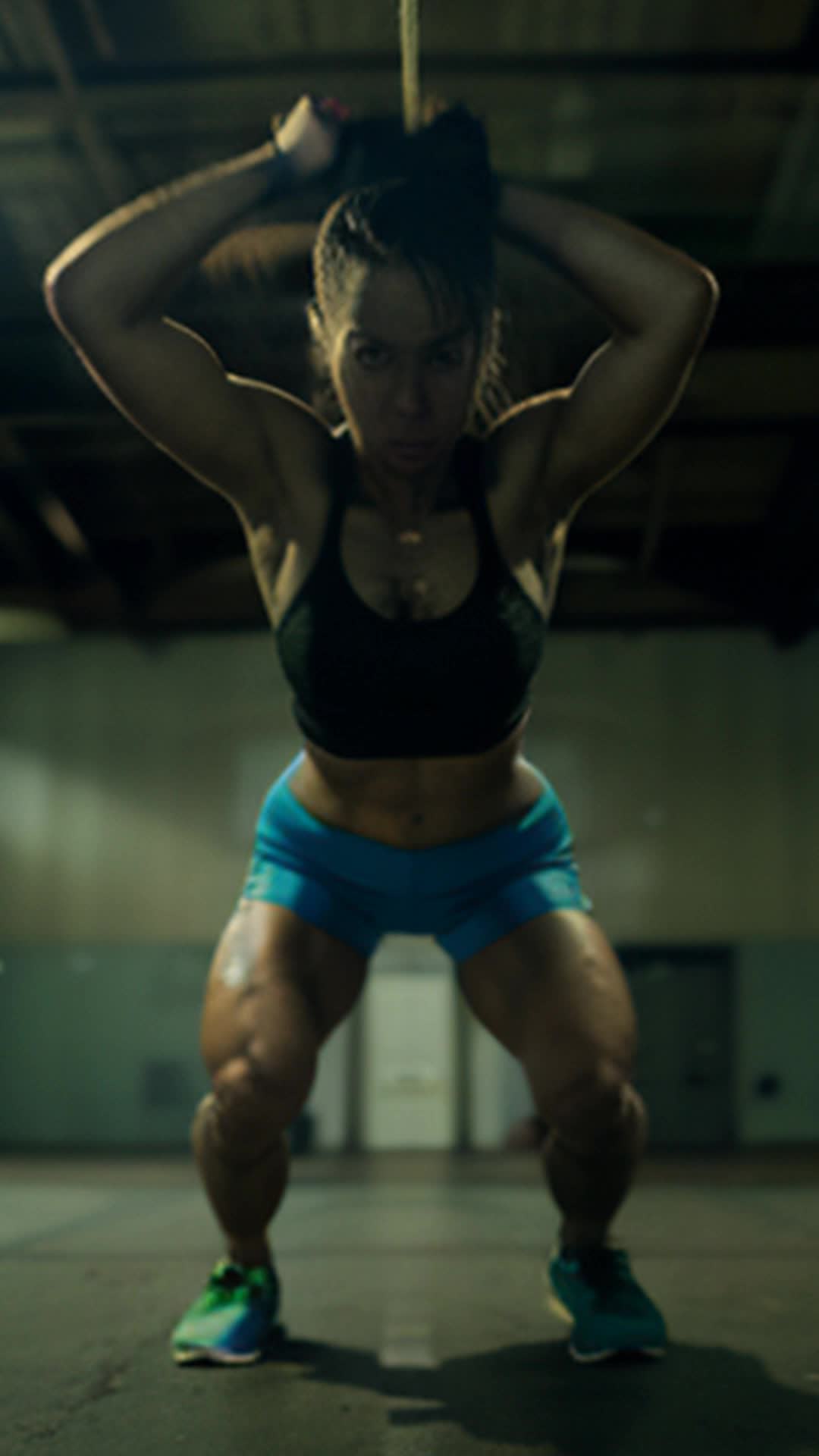 Dilapidated gym interior, flickering overhead lights, female athlete, intense lunging, worn-out equipment creaking, muscles visibly strained, rush of exertion, nostalgic, gritty atmosphere, nostalgic, high-energy