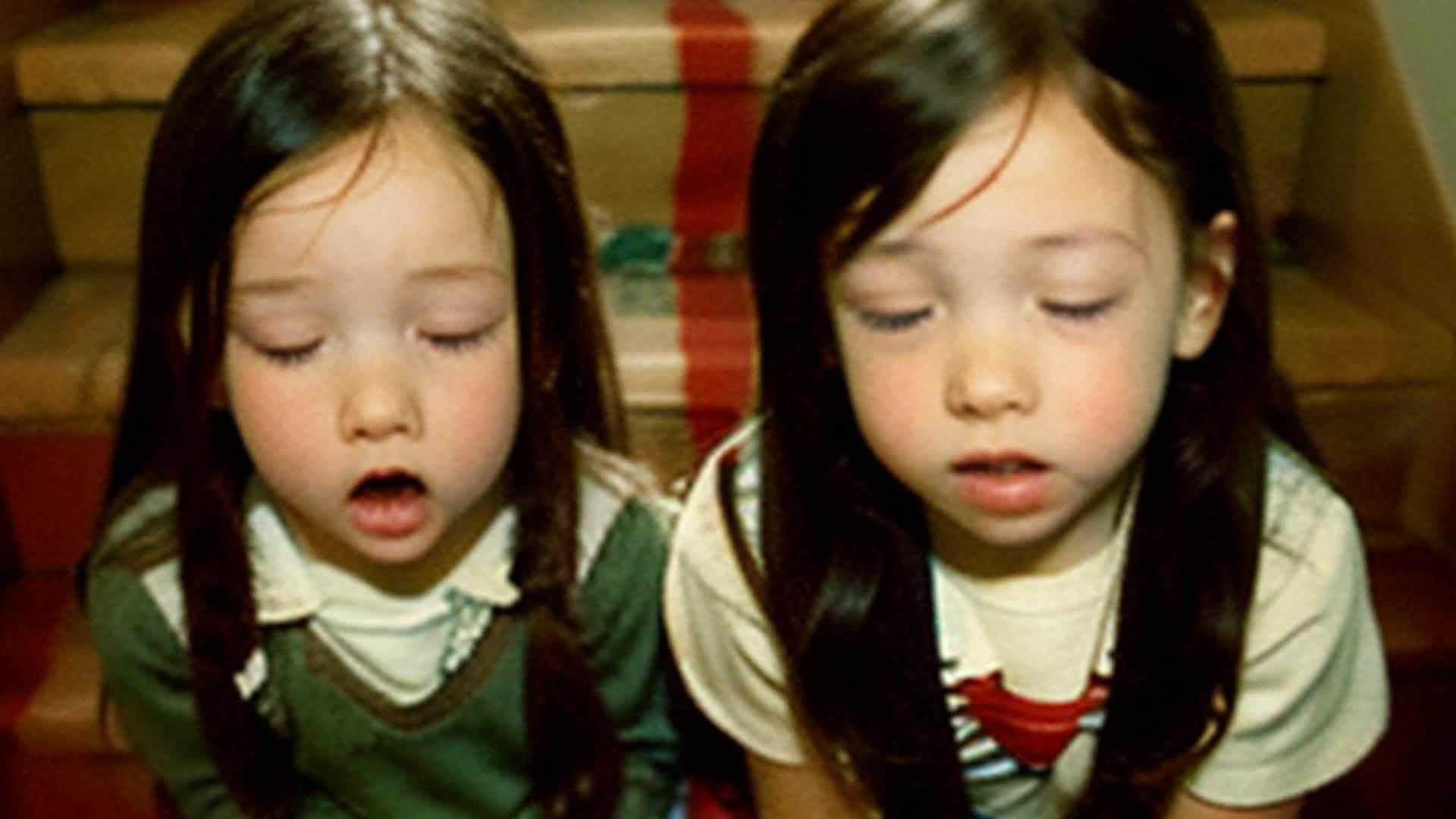 3 little kids listening from the staircase