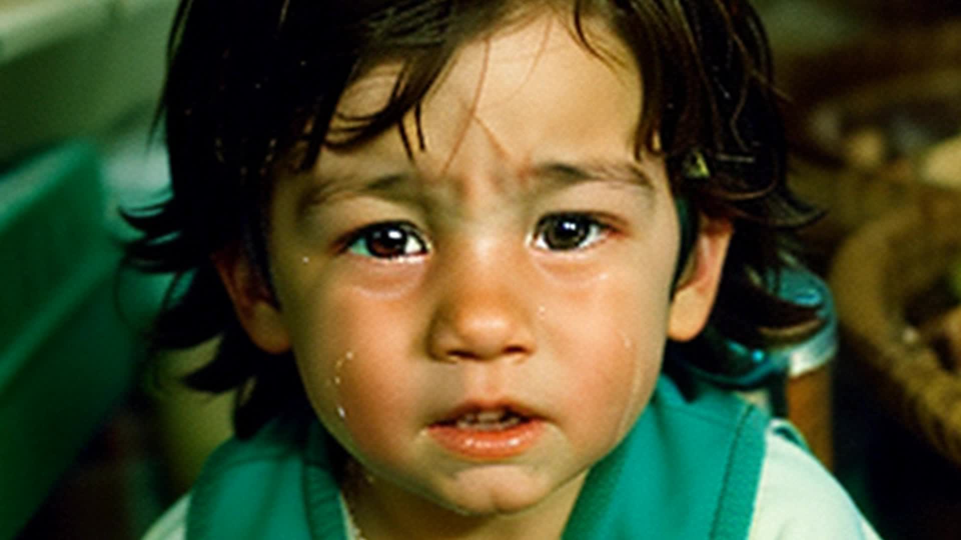 sad little crying brunette boy