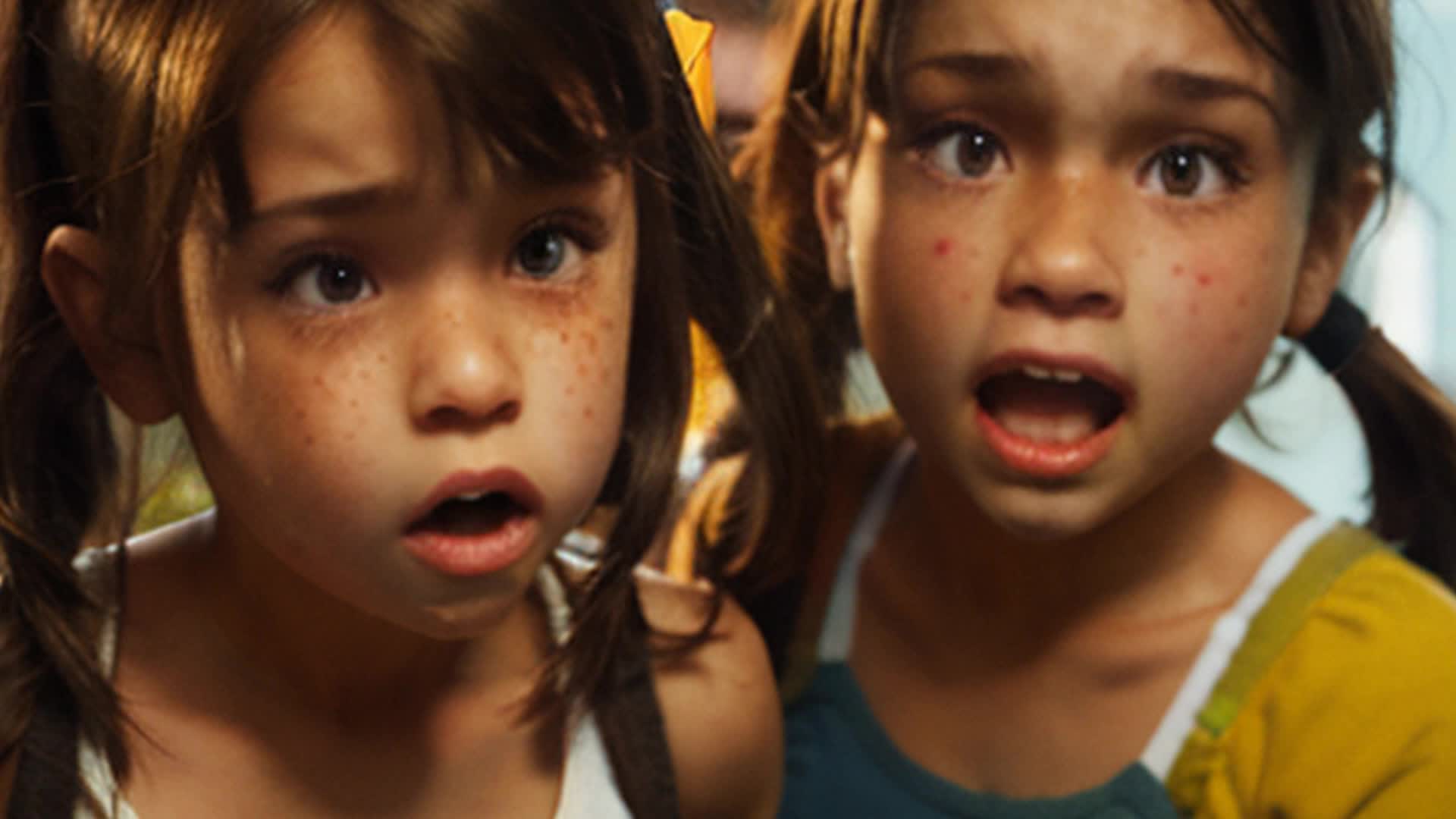 a little brunette girl fighting with her two little brunette brothers