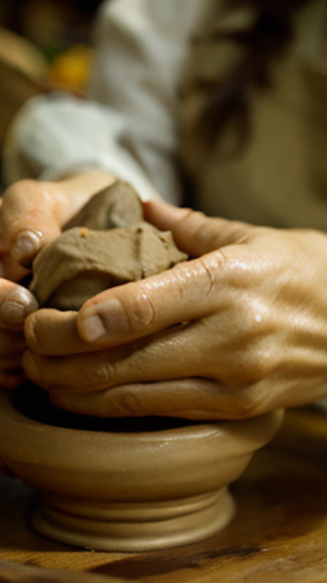 Emma skilled potter trembling hands shaping clay close up bustling farmer's market background