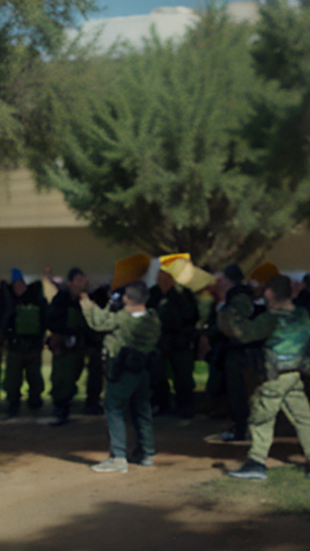 Branch Davidians shouting prayers preparing to defend spiritual convictions against siege loud megaphone demands background armed agents closing in wide angle tense standoff atmosphere