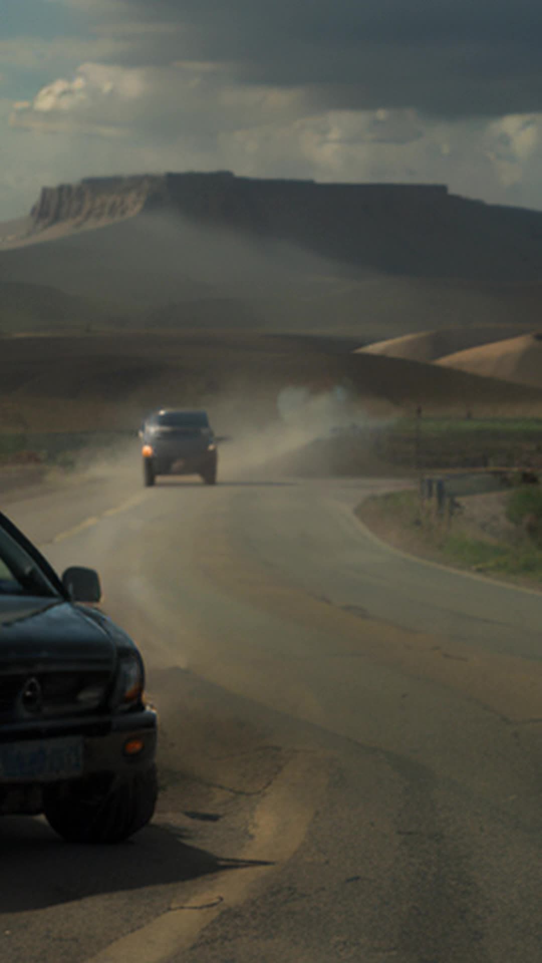 Serene Texas landscape suddenly chaotic as federal agents besiege David Koresh followers dust clouds swirl confusion reigns Koresh calls for calm amidst chaos wide angle dusty Texas landscape