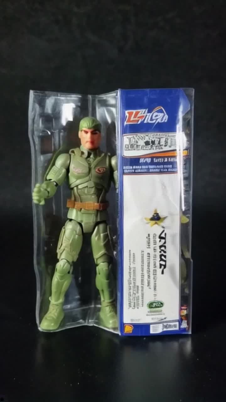 A military action figure is trapped inside his blisterpack and trying to escape, the blisterpack is labeled with text ACTION ANDY and also has the toy company logo 