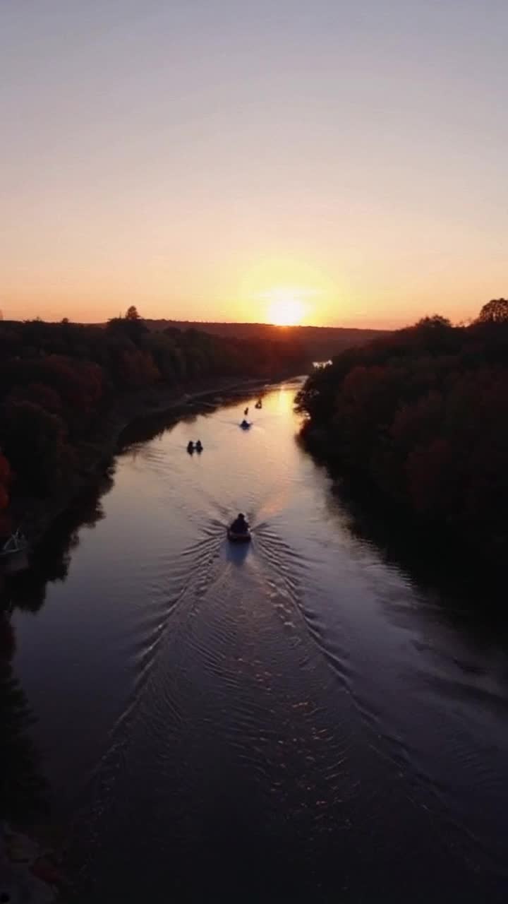 Tubing down the sugar river in green county wisconsin  its a beautiful fall evening and everyone is having fun floating on their tubes at golden hour detailed 