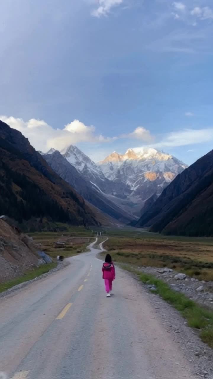 Create a vedio a girl walking on the road which infront of himalaya mountains