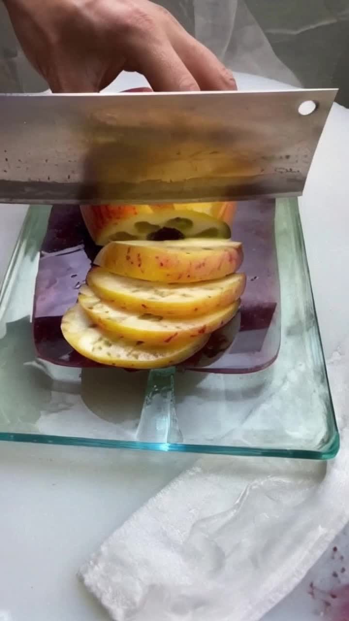 KNIFE slicing GLASS two hands cut fruits placed on glass board after slicing fruits they sliced glass board 