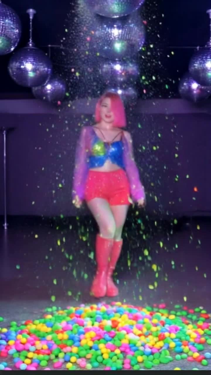 Colorful confections swirling around vibrant dancers adorned in sweetthemed costumes twirling gracefully amidst a sugary wonderland Glimmering rainbows of jellybeans and lollipops light up the scene as confetti showers of powdered sugar create a magical atmosphere Rhythmic beats pulse through the air as the dancers glide and leap with joyful abandon leaving trails of glittering sprinkles behind