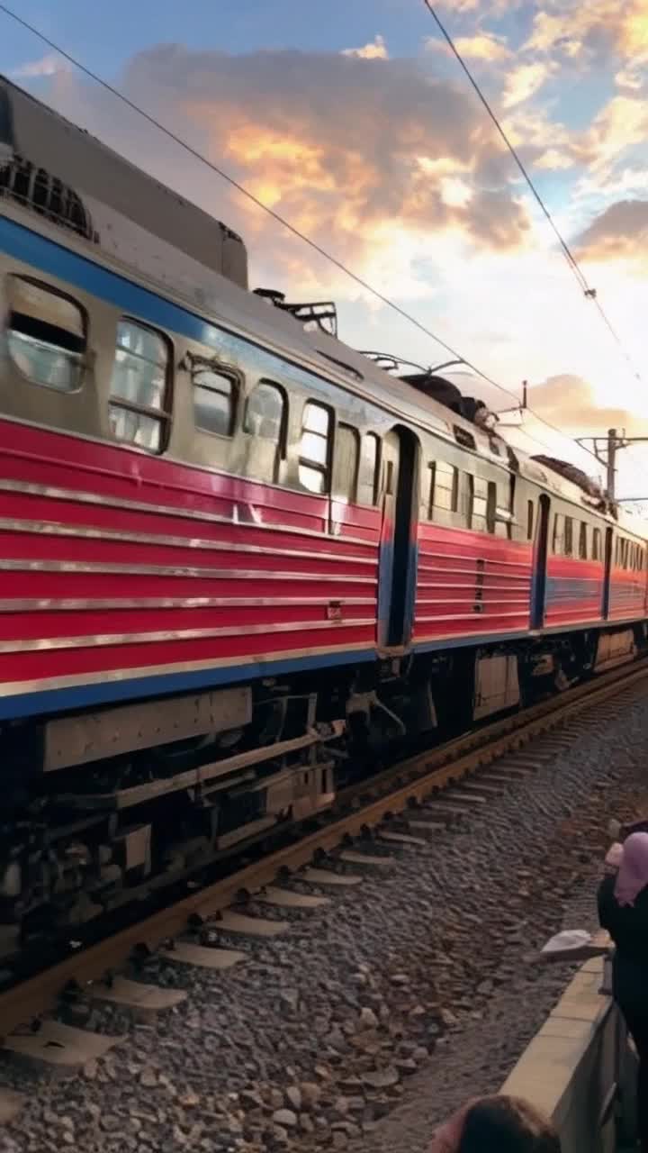 Dynamic train thundering down tracks vibrant red and blue colors vivid lights flashing heroic figure swinging through the air powerful webs shooting from wrist Actionpacked rescue daring leap into the fray catching passengers with swift precision Background bustling city skyline bright sunset casting golden hues urban chaos cheering crowd gathered below awe and admiration in their eyes