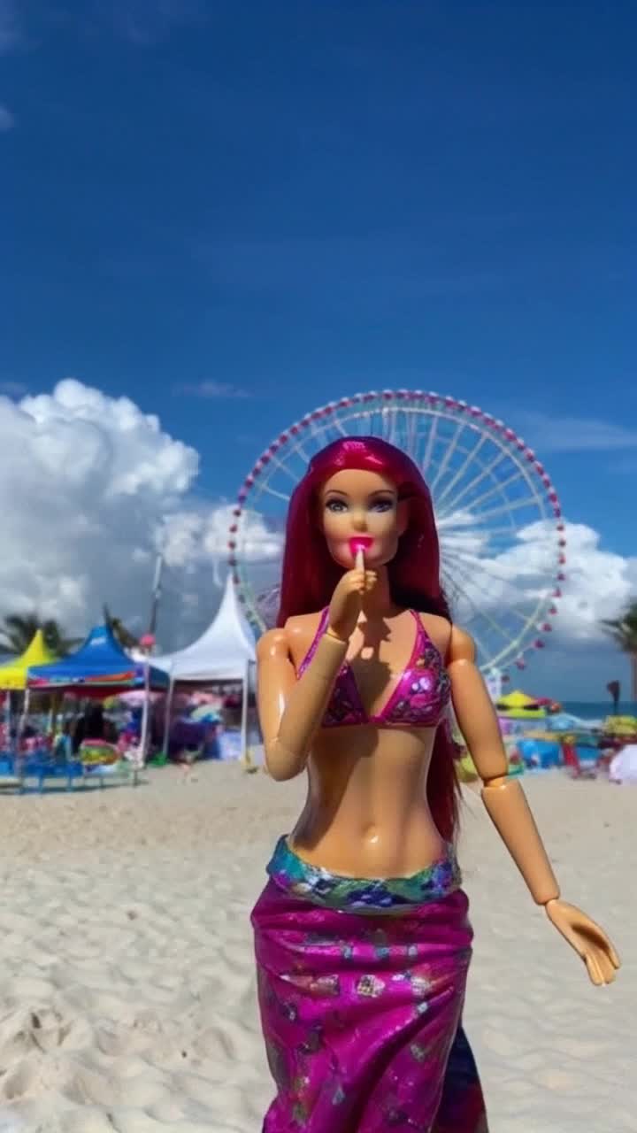 Vibrant Barbie doll with dazzling attire sparkling in sunlight Chewing colorful gum with playful delight Twinkling beach carnival filled with spinning Ferris wheel bright tents aroma of cotton candy waving palm trees against azure sky