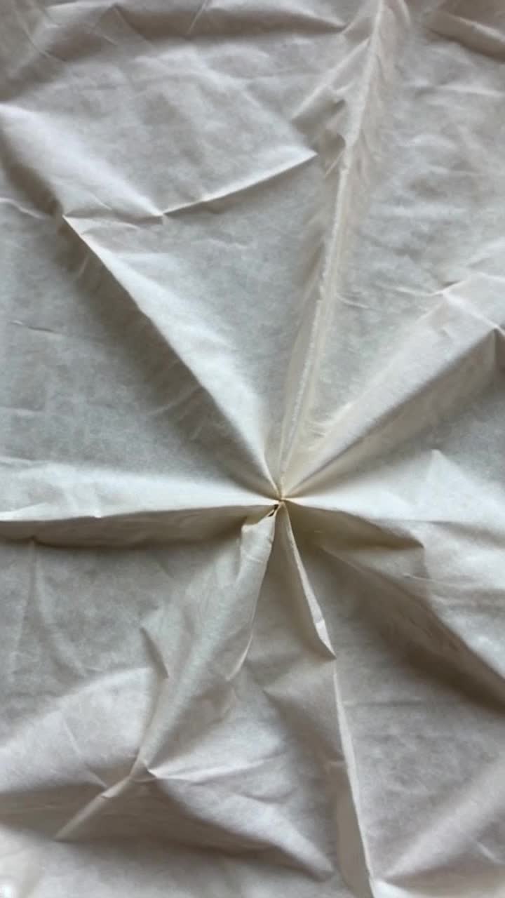Wildly crumpled piece of paper show all the crevices and creases