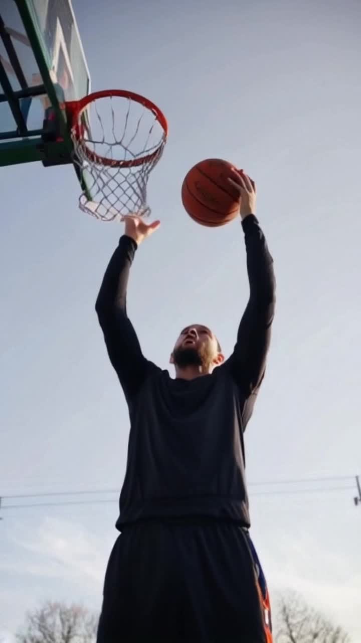 Jason Richardson impresses with his technique and complexity, jumping up and throwing the ball into the hoop with both hands from the top down Super detailed throwing motion and tracking of technique and complexity on camera