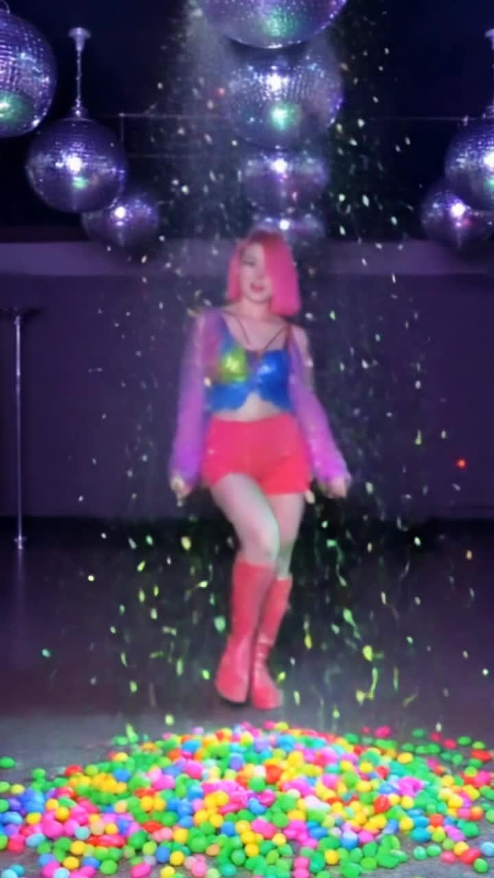 Colorful confections swirling around vibrant dancers adorned in sweetthemed costumes twirling gracefully amidst a sugary wonderland Glimmering rainbows of jellybeans and lollipops light up the scene as confetti showers of powdered sugar create a magical atmosphere Rhythmic beats pulse through the air as the dancers glide and leap with joyful abandon leaving trails of glittering sprinkles behind