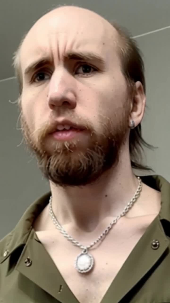 Cyraxx a thin and sickly goblin looking fellow thinking about his precious new silver Cuban chain necklace,