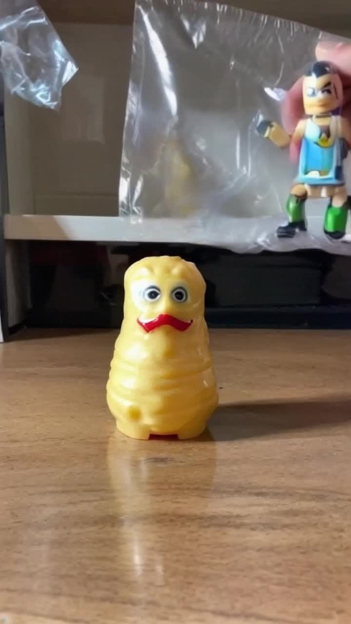 One GI Joe action figure is torn out of its packaging and flung at a standing mister potato head that falls over and all its face pieces fall off