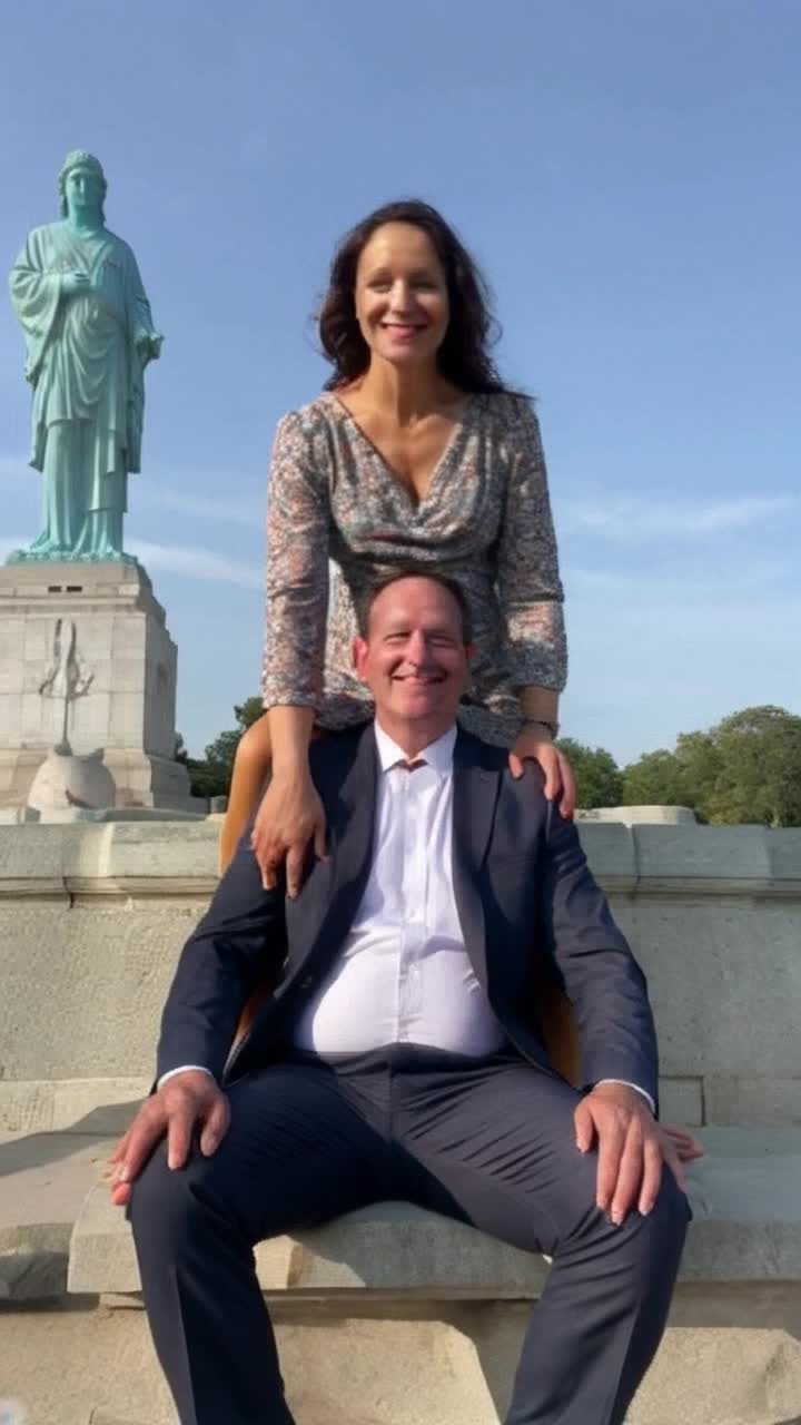 A 90 foot tall woman sits on the lap of the president at the Lincoln Memorial flirting with the statue