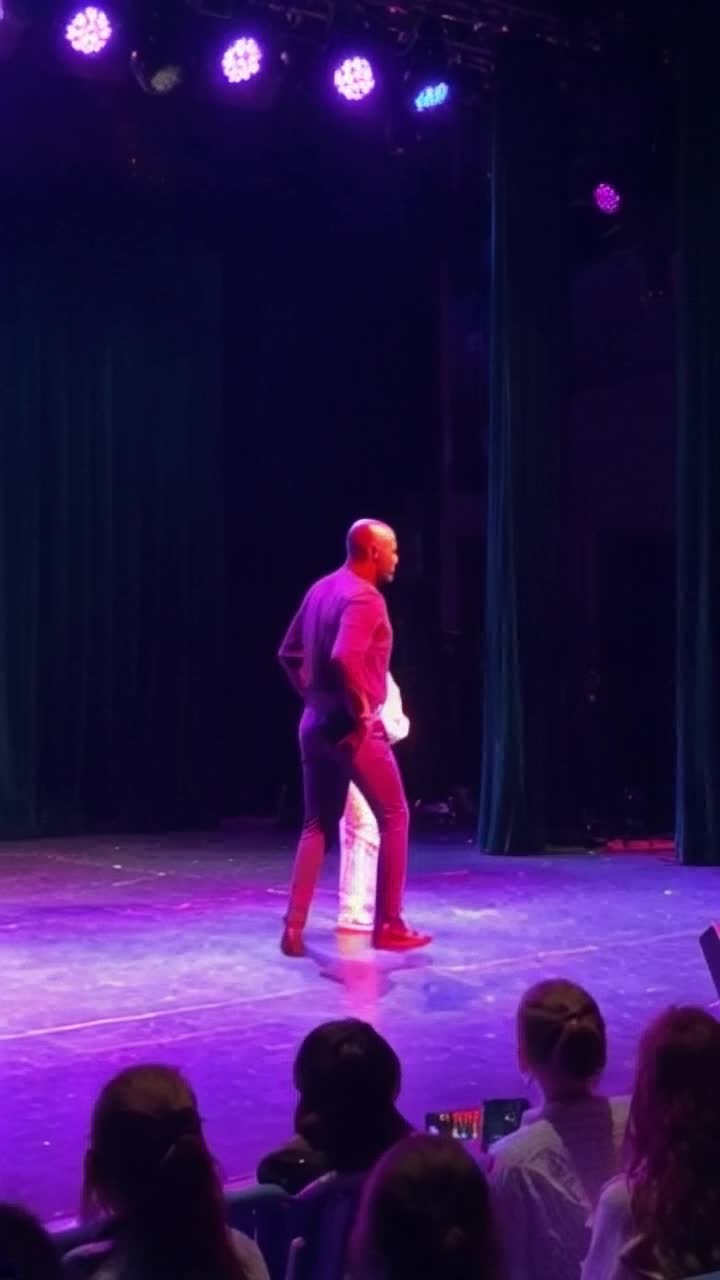 Michael Jackson thrusting his hips towards a crowd of parents with their kids and signaling to the parents that he had a lot of money