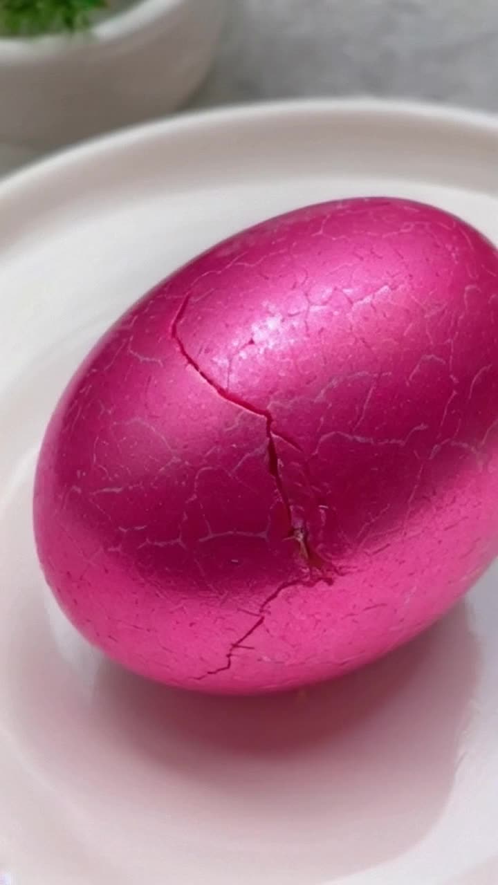 A pink camouflage Easter egg hatching 