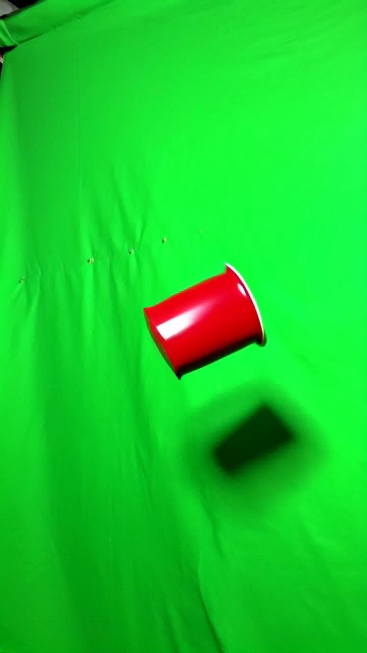 Red tupperware flies across the green screen