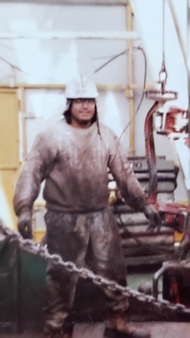 Hardworking father, grinning and moving his head to the tune of heavy rock guitar solo as pyrotechnic explosions and lasers erupt from the distant mountain ranges the man overstanding a vast construction miniature landscape of rural rocky mountains ranges rising up from the Earth