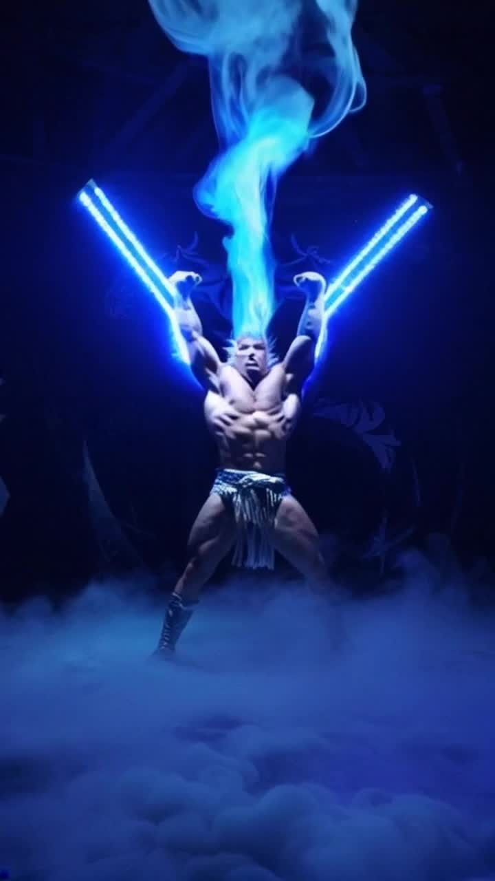 Chosen warrior with spiky hair radiating brilliant atomic blue energy flexes powerful muscles under pulsating glow of vibrant blue gel lighting energetic surge cascading around him illuminating the scene with ethereal brilliance soft shadows dancing on the ground creating a mystical atmosphere that heightens his presence symbols of strength and divinity etched into the environment swirling mist enhancing the intensity exuding a fierce determination that captivates viewers drawing them into this electrifying moment