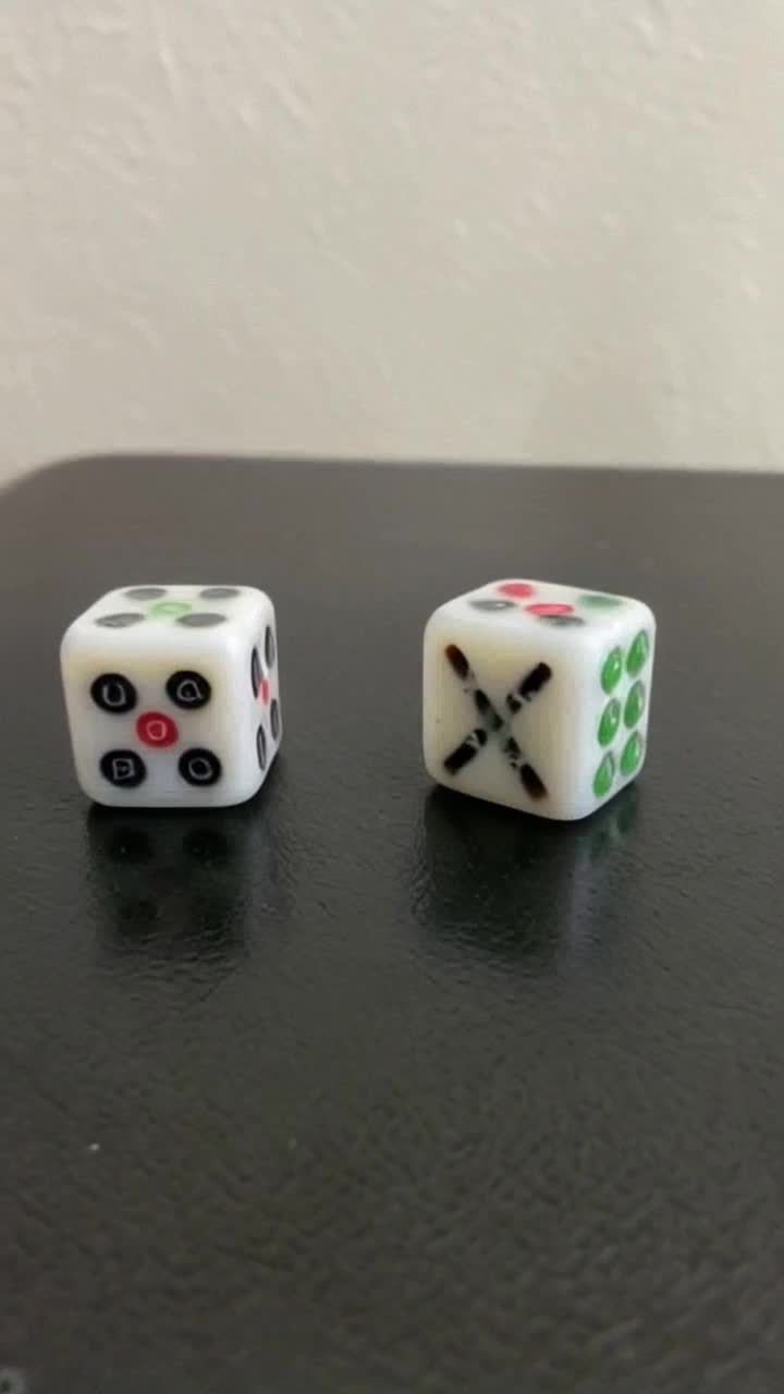 2 dice rolling on a table