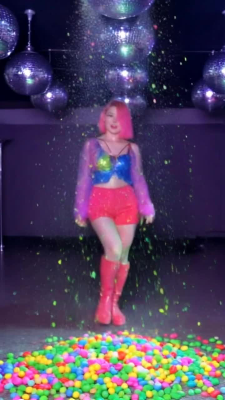 Colorful confections swirling around vibrant dancers adorned in sweetthemed costumes twirling gracefully amidst a sugary wonderland Glimmering rainbows of jellybeans and lollipops light up the scene as confetti showers of powdered sugar create a magical atmosphere Rhythmic beats pulse through the air as the dancers glide and leap with joyful abandon leaving trails of glittering sprinkles behind