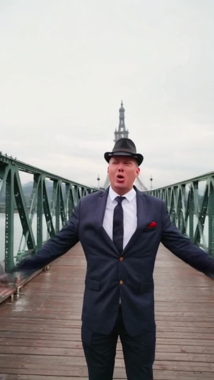 Closeup of Putin, the troll thief, standing in the middle of the Crimean Bridge also known as the Kerch Strait Bridge, Kerch Bridge with his hands up in the air and shouting like a madman